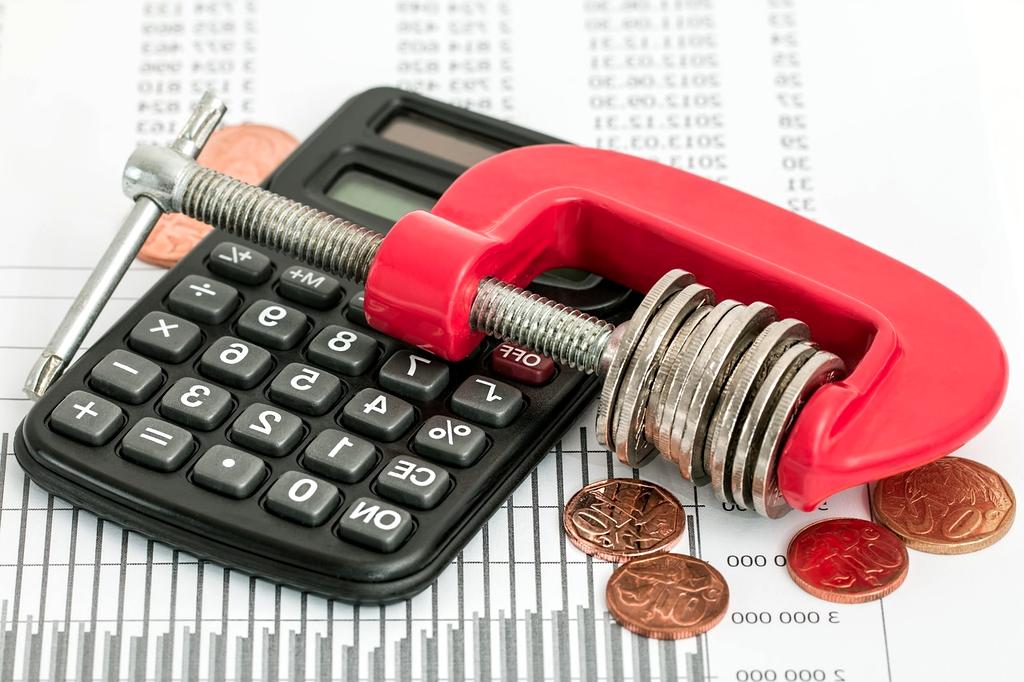Calculator and money representing debt repayment strategy